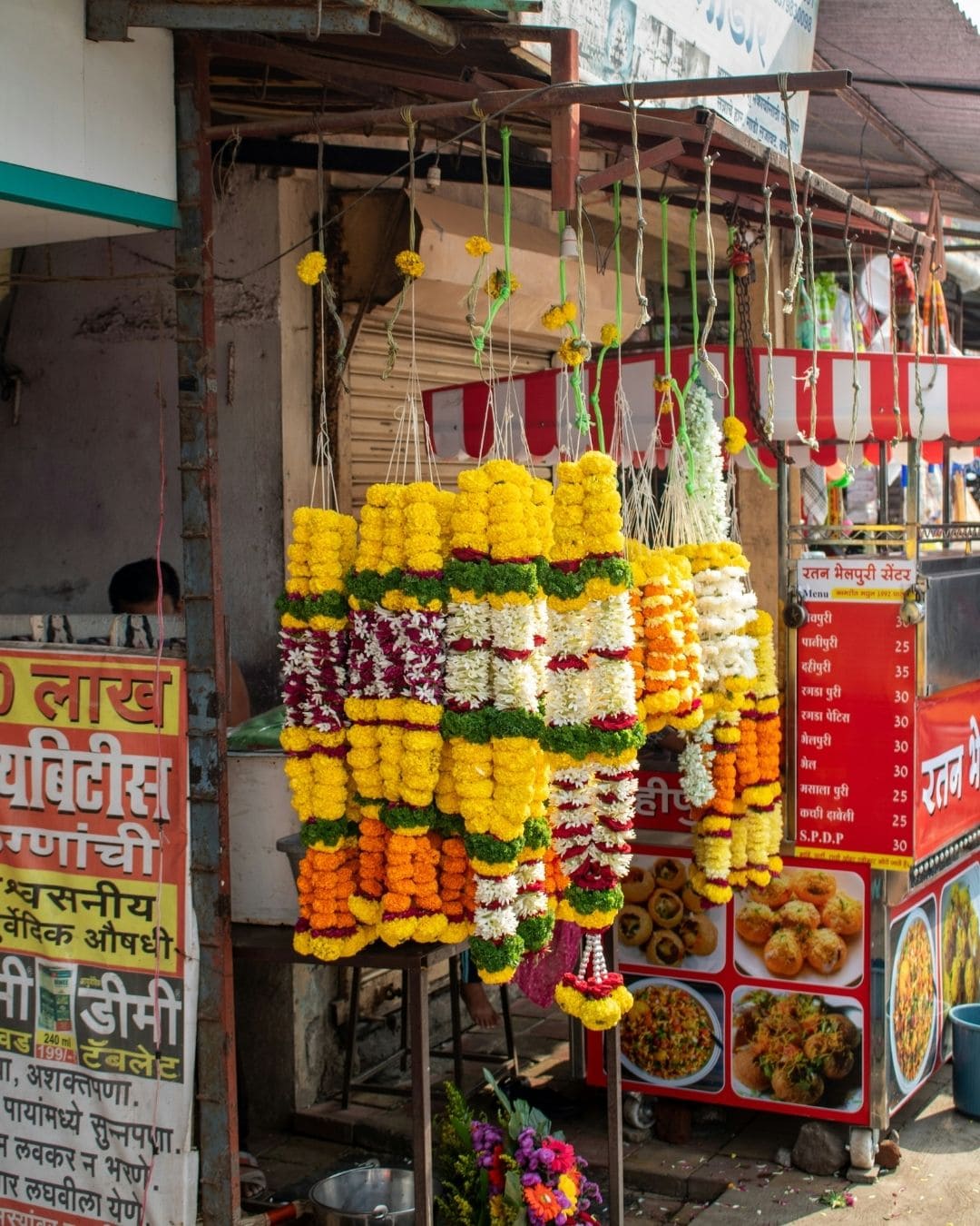 Farbenfrohe Blumenkränze auf einem indischen Marktstand, vorbereitet für Feste und Zeremonien