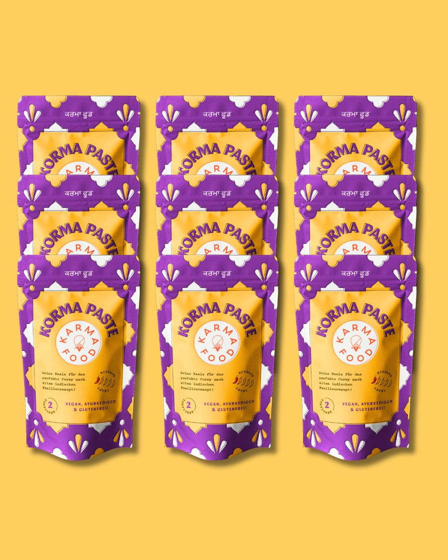 Korma Paste von Karma Food in auffälliger lila-gelber Verpackung, vegane ayurvedische Curry-Basis ohne Gluten